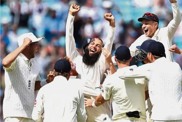  ??  ?? This day in history: England’s Moeen Ali (centre) and teammates celebrate their victory on the fifth and final day of the third Test match against South Africa at The Oval in London on Monday. Moeen’s hat-trick saw England complete a 239-run win...