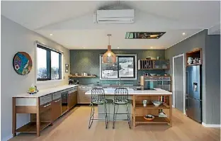  ?? MELANIE CRAIG ?? In this kitchen, designer Melanie Craig used colours that are repeated in the wider living area, and positioned dual ovens on the back wall.