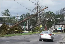  ?? STEVE HELBER — THE ASSOCIATED PRESS ?? Traffic diverts around downed power lines Monday in Metairie, Louisiana.