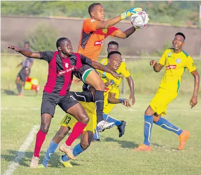  ?? PHOTO BY LENNOX ALDRED ?? Vere United goalkeeper Shavar Wilson jumps to collect a ball ahead of Arnett Gardens’ Fabian Reid (left) and Vere teammate Andre Gayle (centre) during their Red Stripe Premier League game played at the Wembley Centre of Excellence­c in Hayes, Clarendon, yesterday.