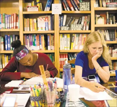  ?? PHOTOS BY REZA A. MARVASHTI — FOR THE WASHINGTON POST ?? Lauren Dent, left, an eighth-grade middle schooler, studies while Julia Ross checks a client’s work. Ross went into business for herself after having to leave a career for health reasons.