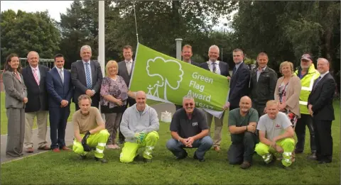  ??  ?? Cathaoirle­ach Pip Breen raises the An Taisce Green Flag Award at Gorey town park associatio­n with Gorey Gateway Scheme. Gorey Town Park is one of the first parks in Ireland to achieve such an award.