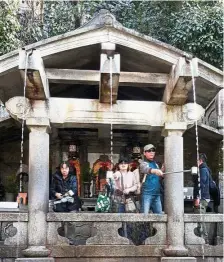  ??  ?? Visitors collecting water from the three fountains at the Kiyomizu Temple, said to endow drinkers with good health, longevity and wisdom.