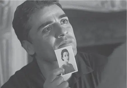  ?? MGM ?? Peter Malkin (Oscar Isaac) shows a picture of his late sister to Adolf Eichmann (Ben Kingsley) in the Nazi thriller “Operation Finale,” in theaters Wednesday.