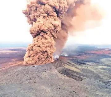  ??  ?? A column of robust, reddish-brown ash plume spews from the Kilauea volcano after a magnitude 6.9 earthquake shook the Big Island of Hawaii on Friday.