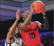  ?? DAVID JABLONSKI / STAFF ?? Dayton’s Jalen Crutcher shoots against Butler’s Kamar Baldwin at the Battle 4 Atlantis on Wednesday at Paradise Island, Bahamas.