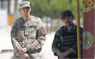  ?? JAWAD JALALI, EUROPEAN PRESSPHOTO AGENCY ?? A U.S. soldier inspects the aftermath of a suspected Islamic State attack last month in Kabul. The war in Afghanista­n marks its 16th anniversar­y in October.