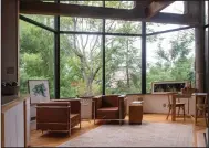  ?? (TNS/Pittsburgh Post-Gazette/Steve Mellon) ?? Expansive glass windows dominate the living room in architect Tasso Katselas’ home.