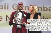  ??  ?? Actor Baykali Ganambarr, winner of the Marcello Mastroiann­i Award for Best New Young Actor, with jury member Naomi Watts.