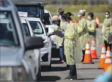  ?? Gina Ferazzi Los Angeles Times ?? A LINE of drivers backs up for coronaviru­s tests given by medical personnel in Lake Elsinore. A study suggests that California’s stay-at-home order may keep the hospital overload below catastroph­ic levels.