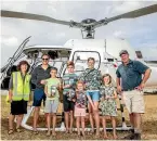  ?? RICKY WILSON/FAIRFAX NZ ?? Precision Helicopter­s Blenheim co-owners Tanya Andrews, left, and Neal Andrews, far right, about to take the Vermeylen family on a flight to the Marlboroug­h Sounds.