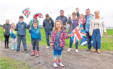  ??  ?? Families gathered on the roadside in Aberdeensh­ire to cheer on their favourites.