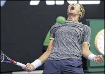  ?? AARON FAVILA / ASSOCIATED PRESS ?? Denis Istomin, a No. 117-ranked wild-card entry from Uzbekistan, exults at the end of his victory over Novak Djokovic — just his second career win against a top-10 player.