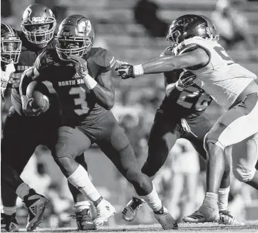  ?? Joe Buvid / Contributo­r ?? North Shore running back Zach Evans, left, breaks through Beaumont West Brook’s defense en route to the end zone for a second-half touchdown Friday night at Galena Park ISD Stadium.