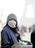  ?? —REUTERS ?? COVERED A man wears a face mask amid an outbreak of a new coronaviru­s.