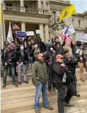  ??  ?? Stay-at-home order protesters on the capitol steps in Lansing, Mich. File photo