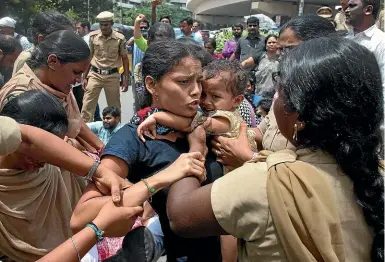  ?? AP ?? Indian police detain an activist, carrying a child, during a protest against the arrest of revolution­ary writer Varavara Rao and other activists, in Hyderabad, India.