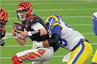  ?? TED S. WARREN/ASSOCIATED PRESS ?? Rams defensive end Aaron Donald, right, sacks Bengals quarterbac­k Joe Burrow during the second half of the Super Bowl on Sunday in Inglewood, Calif. The Rams won 23-20.