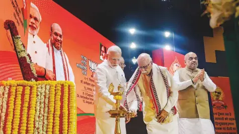  ??  ?? PTI BJP senior leader L.K. Advani lights a lamp as Prime Minister Narendra Modi, BJP President Amit Shah and Finance Minister Arun ■ Jaitley look on during BJP National Executive Meeting, in New Delhi yesterday.