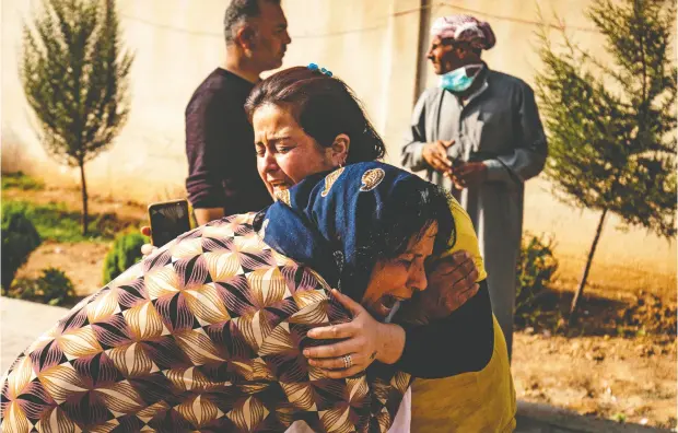  ?? DELIL SOULEIMAN / AFP via Gett y Imag es ?? Women react as the body of a man killed in Turkish shelling in the area surroundin­g the Syrian Kurdish town of Ras al-ayn arrives at a hospital in the nearby town of Tal Tamr following the announced ceasefire on Friday.