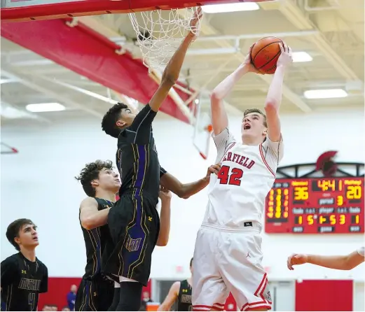  ?? WORSOM ROBINSON/FOR THE SUN-TIMES ?? Deerfield center Brandon Lieb, shooting over Rolling Meadows star Max Christie, had 14 points and 14 rebounds Wednesday.