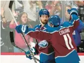  ?? JOHN LOCHER/AP ?? Avalanche center Darren Helm, left, celebrates his goal with center Andrew Cogliano in Game 2 of the Stanley Cup Final on Saturday in Denver.