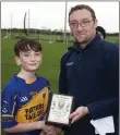  ??  ?? Tomacork’s Richard Greene receives his Wicklow People Man of the Match award from Brendan Lawrence.