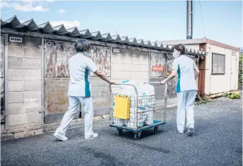  ?? JAMES WHITLOW DELANO/THE NEW YORK TIMES ?? Health care workers collect used adult diapers on Oct. 7 at the Daisen Rehabilita­tion Hospital in Houki, Japan. With adult-diaper use increasing in rapidly aging Japan, Houki has found a way to deal with the waste.