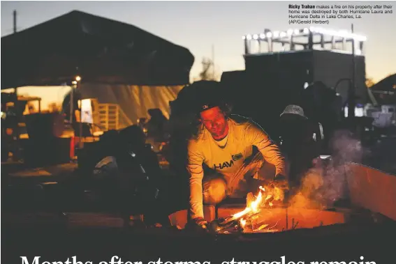  ??  ?? Ricky Trahan makes a fire on his property after their home was destroyed by both Hurricane Laura and Hurricane Delta in Lake Charles, La. (AP/Gerald Herbert)