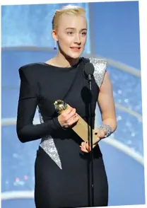  ??  ?? Saoirse Ronan accepts the award for best actress in a motion picture comedy or musical for her role in “Lady Bird.”