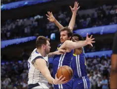  ?? NHAT V. MEYER — BAY AREA NEWS GROUP ?? The Mavericks’ Luka Doncic looks to pass around the Warriors’ Nemanja Bjelica in the fourth quarter of Game 4of the NBA Western Conference finals Tuesday.