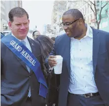  ?? STAFF PHOTO BY ANGELA ROWLINGS ?? PARADE PALS: Boston Mayor Martin J. Walsh, left, and City Councilor Tito Jackson, who is running for mayor, chat at yesterday’s Greek Independen­ce Day Parade.