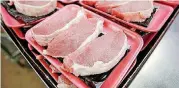 ?? [AP FILE PHOTO] ?? Federal government regulators proposed changes Friday in the way most hogs slaughtere­d for meat in the United States are processed in a series of new rules that officials say improve industry practices but critics say could imperil food safety.