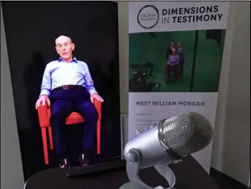  ?? David J. Phillip The Associated Press ?? A Dimensions in Testimony exhibit at the Holocaust Museum Houston lets guests have a virtual conversati­on with Holocaust survivor William Morgan.