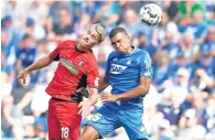  ?? AP ?? Freiburg’s Nils Petersen (left) and Hoffenheim’s Kevin Akpoguma go for a header. —