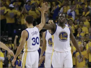  ?? JEFF CHIU — THE ASSOCIATED PRESS ?? The Warriors’ Stephen Curry and Draymond Green during their team’s win over the Spurs on May 14 in Game 1 of the Western Conference finals.
