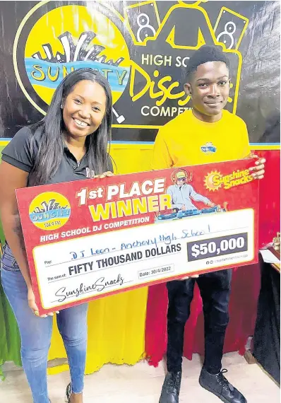  ?? PHOTOS BY STEPHANIE LYEW ?? Sunshine Snacks brand manager, Shantel Hill-Afonso, hands over a $50,000 cheque to the winner of the 2022 SunCity 104.9 FM’s High School Disc Jock Competitio­n, Leon ‘DJ Leon’ Vassell.