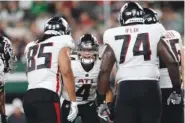  ?? AP PHOTO/ADAM HUNGER ?? Atlanta Falcons quarterbac­k Desmond Ridder (4) huddles with teammates Aug. 22 against the New York Jets during a preseason NFL football game in East Rutherford, N.J.