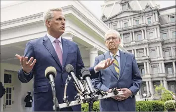  ?? Nicholas Kamm / Getty Imagess ?? Senate Minority Leader Mitch Mcconnell, right, listens as House Minority Leader Kevin Mccarthy speaks to the press, following their meeting with President Joe Biden and Democratic congressio­nal leaders at the White House on Wednesday.