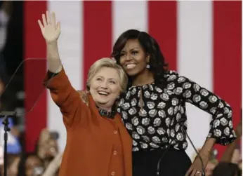  ?? CHUCK BURTON/THE ASSOCIATED PRESS ?? Hillary Clinton with first lady Michelle Obama at a campaign rally in Winston-Salem, N.C., on Thursday.