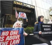  ?? AP PHOTO/BRYAN WOOLSTON ?? Protesters gather in 2023 outside Trump Tower in New York.