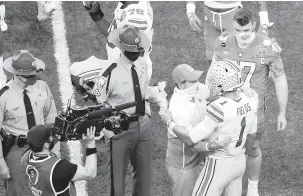  ?? BUTCH DILL/ASSOCIATED PRESS ?? Clemson head coach Dabo Swinney greets Ohio State quarterbac­k Justin Fields on the field after the Sugar Bowl on Friday night in New Orleans. Ohio State won 49-28.