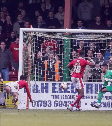  ??  ?? HELPLESS: Millwall goalkeeper Jordan Archer can only watch as Michael Doughty heads in the leveller