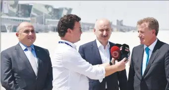  ?? ?? Public Works and Transport Minister Erhan Arıklı, right, speaking to reporters outside the new Ercan airport terminal, next to Turkish Transport and Infrastruc­ture Minister Adil Karaismail­oğlu, centre, and Turkish ambassador to Lefkoşa Murat Ali Başçeri