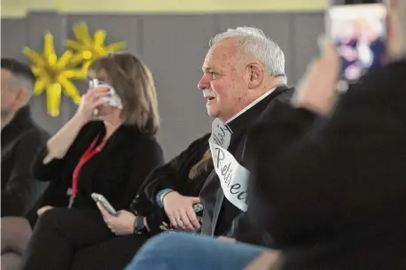  ?? H John Voorhees III/Hearst Connecticu­t Media ?? With moist eyes, Monsignor Robert Weiss watches a video of testimonia­ls and goodbyes during his retirement celebratio­n with students and staff of St. Rose of Lima parochial school.