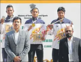  ?? HT ?? 100m winner Nisar Ahmad (centre) and other medallists with sports minister, RVS Rathore (left).