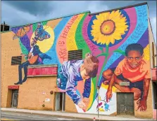  ?? COURTESY OF COMMUNITY MURAL INSTITUTE ?? This vibrant new mural on Boulder Drive in Fitchburg, which was designed in collaborat­ion with the Fitchburg Art Stewards, depicts a musician and two young artists. It’s one of several new murals in the city.