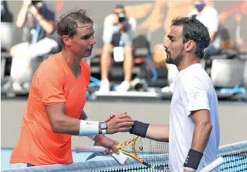  ?? - AFP photo ?? Nadal (left) shakes hands with Fognini after their men’s singles match.