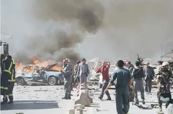  ?? — AFP photo ?? Afghan security forces personnel at the site of the car bomb attack.