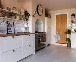  ?? ?? The space at the end of the kitchen was the perfect size for the 1930s cupboard that Laura uses as her pantry. She found the piece on eBay for £100 and painted it white to tie in with the kitchen’s light and airy feel